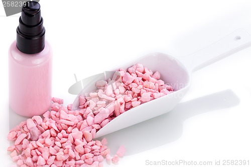 Image of pink body lotion in dispenser and aroma salt isolated