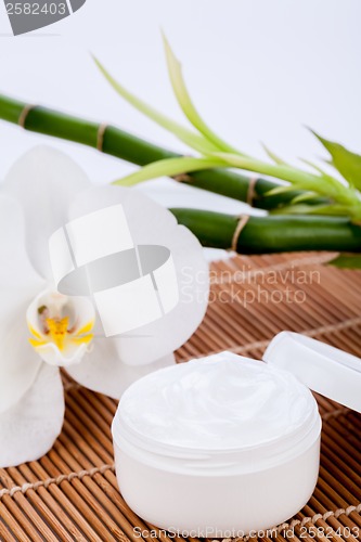 Image of cosmetic face cream on wooden background 