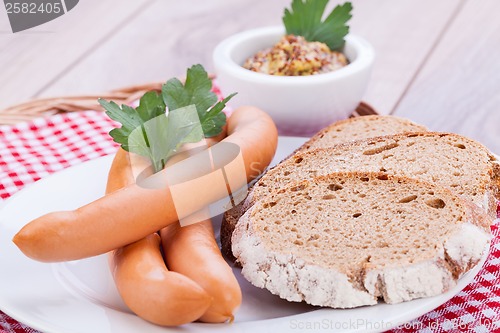 Image of tasty sausages frankfurter with grain bread 