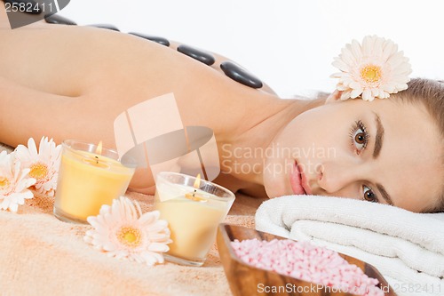 Image of attractive healthy caucasian woman hot stone massage wellness 