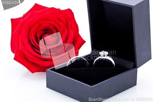 Image of Engagement ring with a bunch of red roses