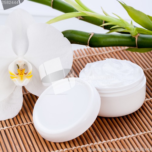 Image of cosmetic face cream on wooden background 