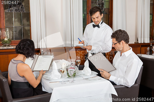 Image of young smiling couple at the restaurant 