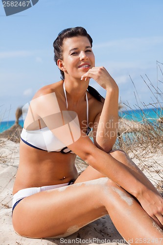 Image of Beautiful young woman in a bikini on the beach