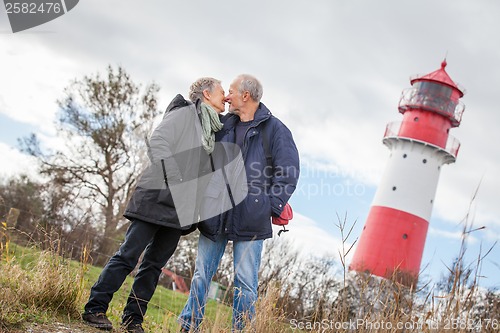 Image of happy mature couple relaxing baltic sea dunes 