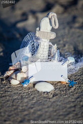 Image of sailing boat and seashell in sand decoration closeup