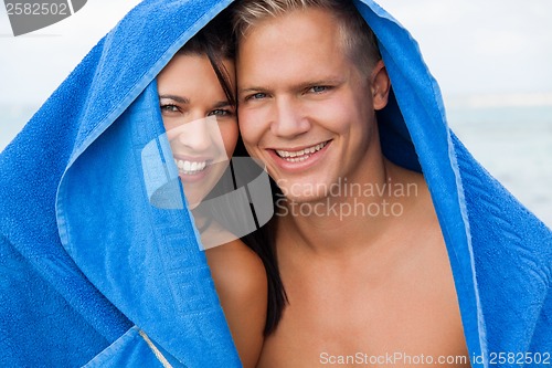 Image of Cheerful couple with a towel covering their heads