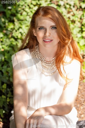 Image of beautiful smiling young redhead woman portrait outdoor