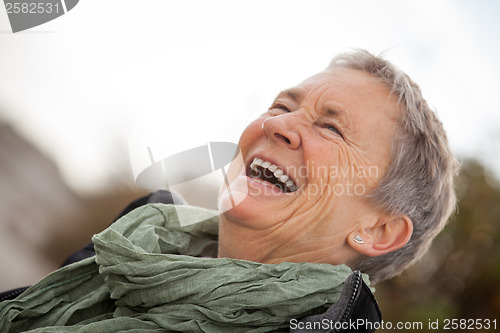 Image of happy grey-haired elderly woman senior outdoor