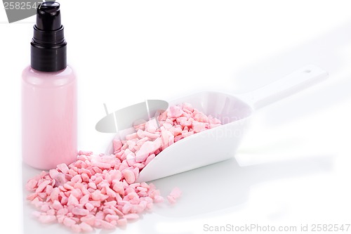 Image of pink body lotion in dispenser and aroma salt isolated