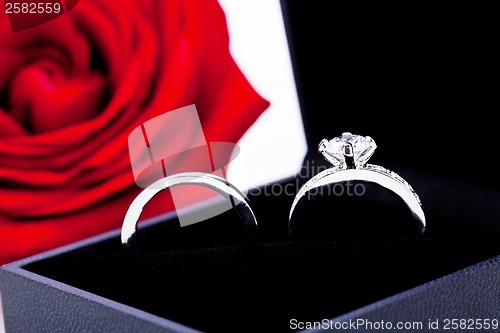 Image of Engagement ring with a bunch of red roses