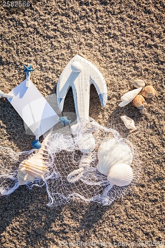 Image of sailing boat and seashell in sand decoration closeup