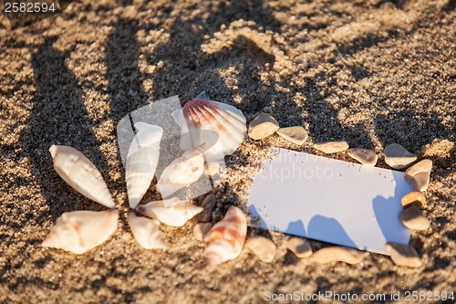 Image of sailing boat and seashell in sand decoration closeup