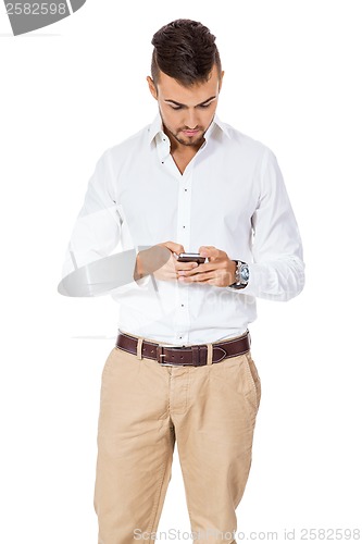 Image of Handsome man reading a message on his mobile