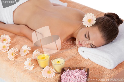 Image of attractive healthy caucasian woman hot stone massage wellness 