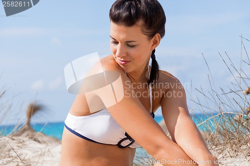 Image of Beautiful young woman in a bikini on the beach