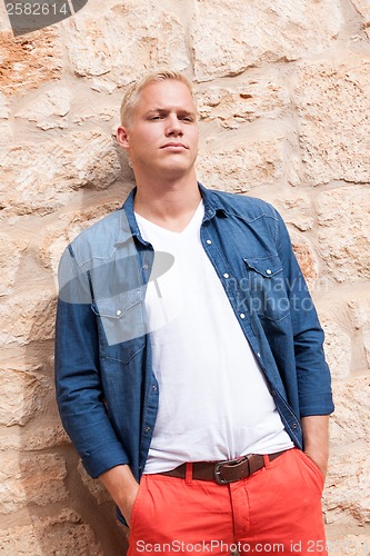 Image of attractive young adult man standing outside 