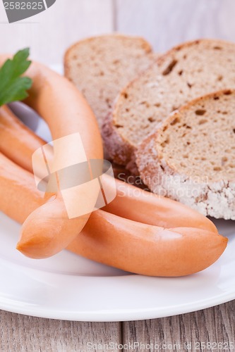 Image of tasty sausages frankfurter with grain bread 