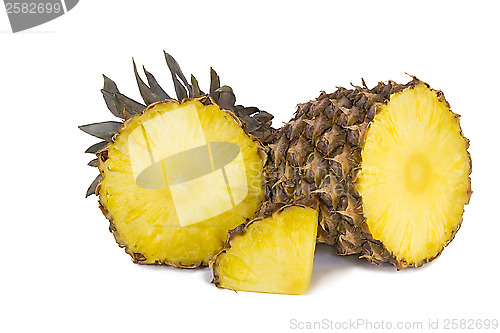 Image of Pineapple and slices of pineapple on a white background.