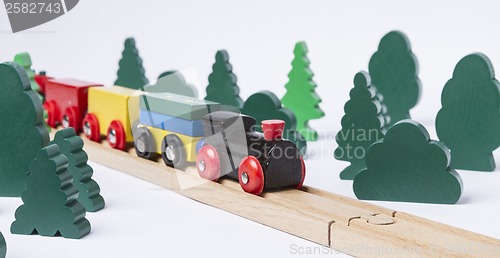 Image of wooden toy train in rural landscape