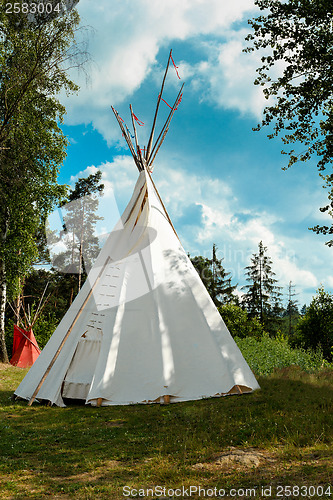 Image of indian tepee against blue sky