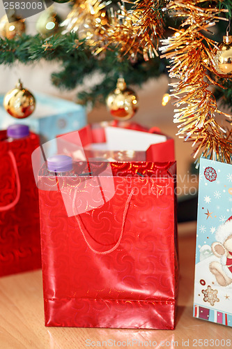 Image of detail of gifts under decorated christmas tree