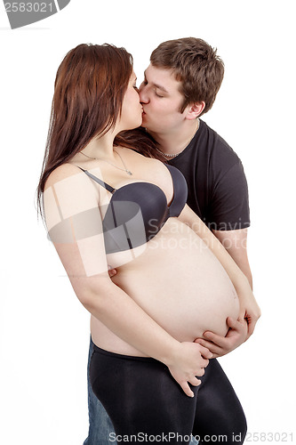 Image of loving happy couple, husband kissing pregnant woman