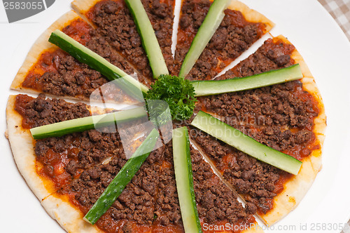 Image of Turkish beef pizza with cucumber on top