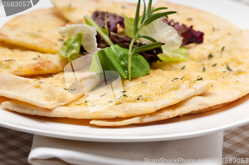 Image of garlic pita bread pizza with salad on top