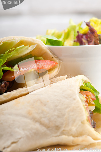 Image of kafta shawarma chicken pita wrap roll sandwich