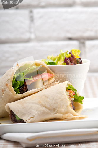 Image of kafta shawarma chicken pita wrap roll sandwich