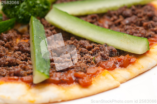 Image of Turkish beef pizza with cucumber on top