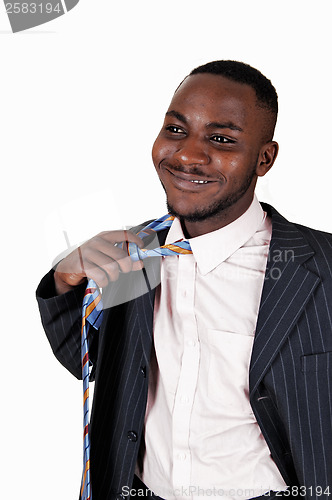 Image of Black man taking off tie.