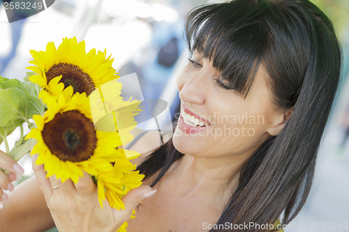 Image of Pretty Italian Woman Looking at Sunflowers at Market