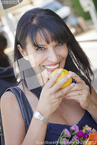 Image of Pretty Italian Woman Smelling Oranges at the Street Market