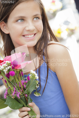 Image of Pretty Young Girl Holding Flower Bouquet at the Market