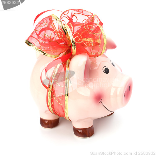 Image of Christmas deposit concept. Piggy bank with festive bow isolated 