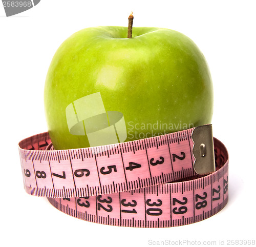 Image of  tape measure wrapped around the apple isolated on white backgro