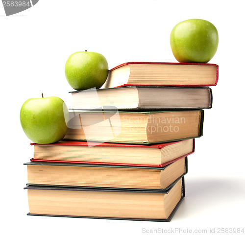 Image of book stack with apple isolated on white background 