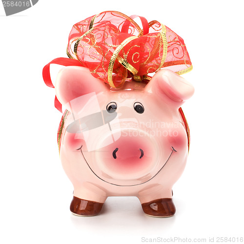 Image of Christmas deposit concept. Piggy bank with festive bow isolated 