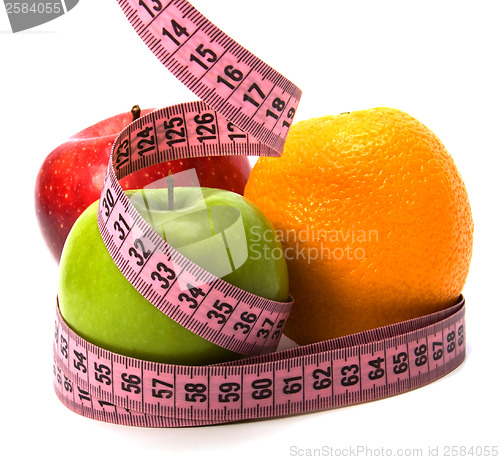 Image of  tape measure wrapped around fruits isolated on white background