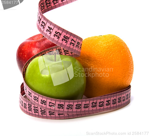 Image of  tape measure wrapped around fruits isolated on white background