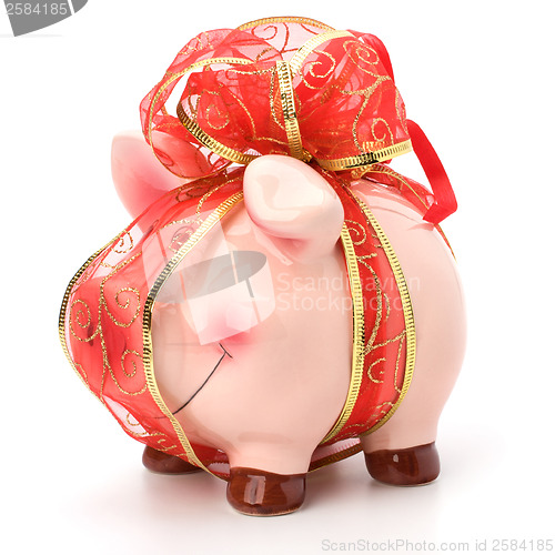 Image of Christmas deposit concept. Piggy bank with festive bow isolated 