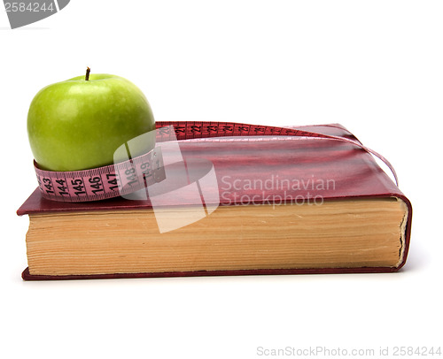 Image of tape measure wrapped around book isolated on white background