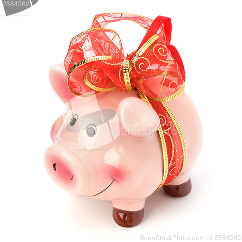 Image of Christmas deposit concept. Piggy bank with festive bow isolated 