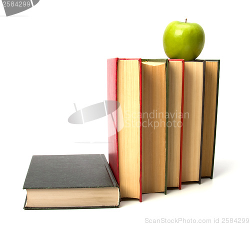 Image of book stack with apple isolated on white background 