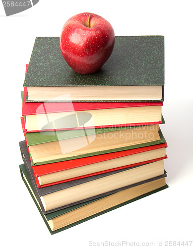 Image of book stack with apple isolated on white background 