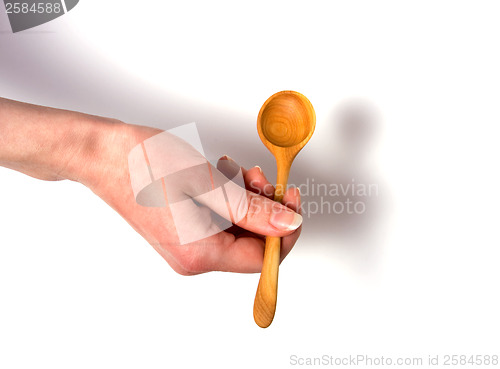 Image of Hand holding wooden spoon isolated on white background