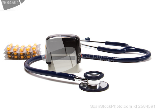 Image of stethoscope, tablets  and doctor seal isolated on white backgrou