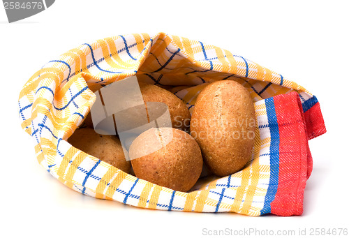 Image of fresh warm rolls over kitchen towel isolated on white background